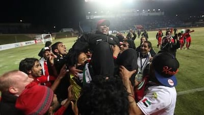 Mahdi Ali is hoisted overhead by the Olympic team.
