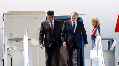 Russia's new ambassador to Finland Pavel Kuznetsov, left, escorts Russian President Vladimir Putin as he disembarks the plane at Helsinki airport in Vantaa, Finland, Monday, July 16, 2018. AP