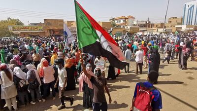 A Sudanese demonstrator waves a national flag during a protest against the October 2021 military coup, in the capital Khartoum, on January 13, 2022. AFP