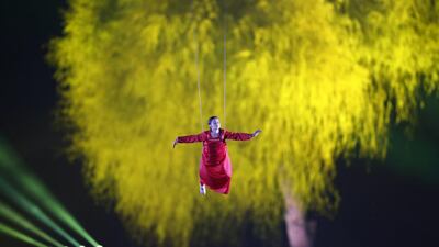 A school student performs during celebrations at the Zayed Sports Stadium. EPA /Ali Haider