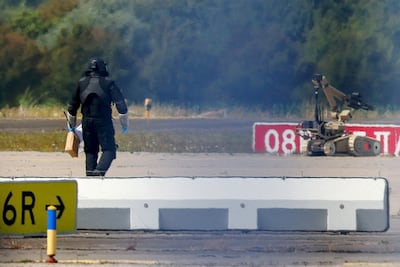 A bomb disposal officer and robot at Leipzig Halle Airport in Germany after a drone was found near the runway. Reuters