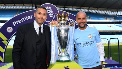 Manchester City chairman Khaldoon Al Mubarak, left, alongside manager Pep Guardiola at the Etihad Stadium following the club's 2017/18 Premier League title success. Getty Images