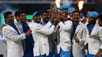 India lifted the Champions Trophy for the second time, 11 years after sharing it with Sri Lanka. Typically of Dhoni, left, he gave the trophy to his teammates before posing for pictures. Michael Steele / Getty Images