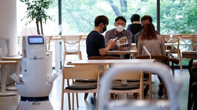Customers wait at a cafe in Daejeon, South Korea, where a robot takes orders, makes coffee and brings the drinks straight to them. Reuters