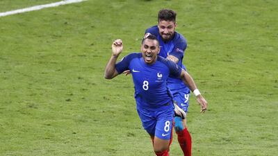France's Dimitri Payet, left, celebrates with his teammate Olivier Giroud after scoring his side's second goal against Romania in the Euro 2016 opener on Friday night in Paris. Michael Sohn / AP / June 10, 2016