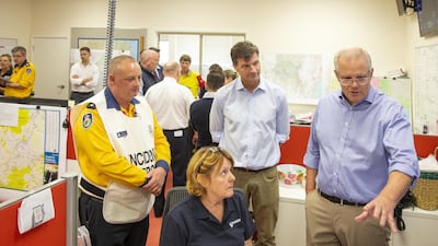 Prime Minister Scott Morrison talks to a volunteer at The Picton Evacuation Centre on December 22, 2019 in Picton, Australia. Getty Images