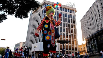 A clown walks down a street in Guadalajara. AFP