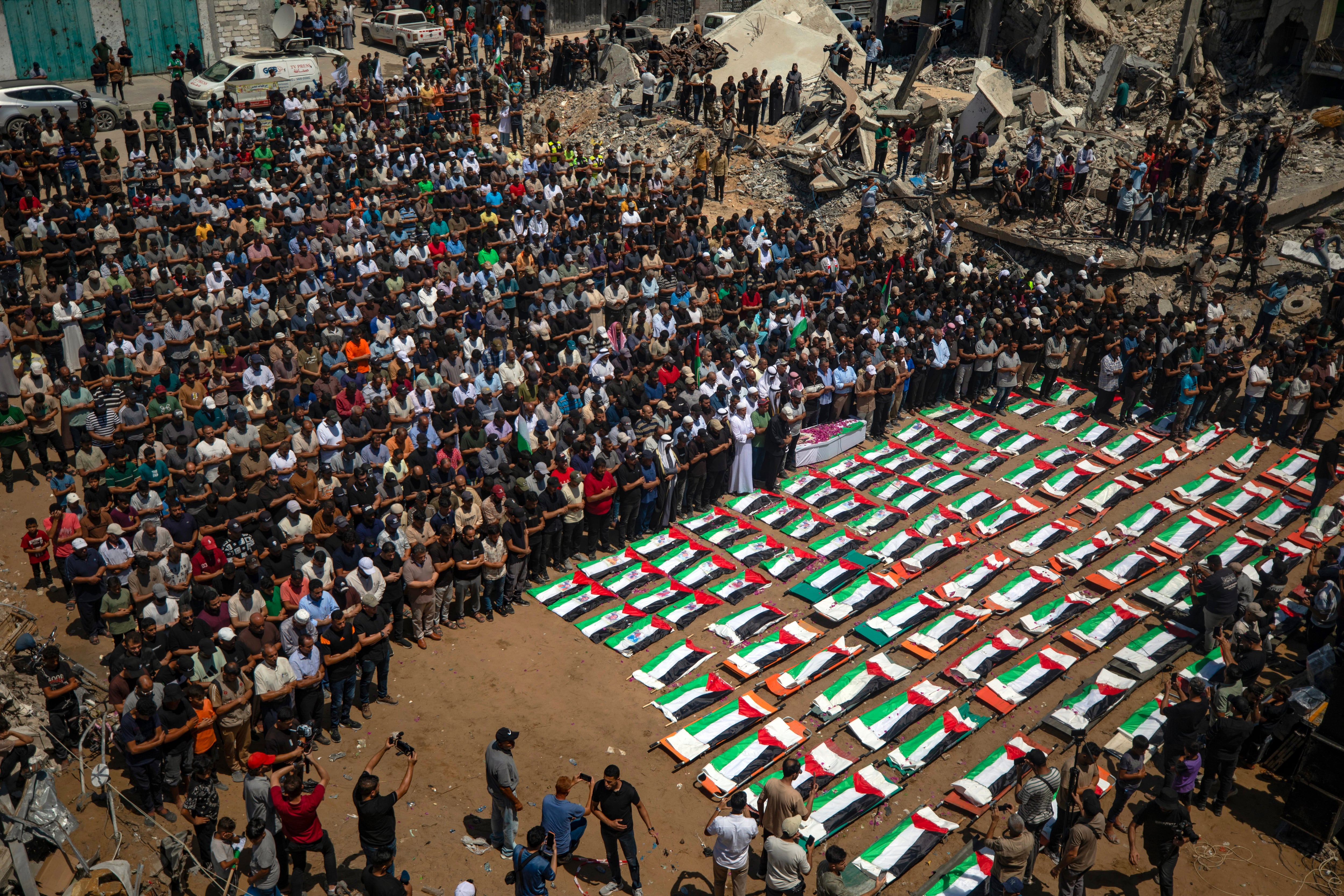 Image linked from the original feed: Gazans mourn 112 people retrieved from rubble almost three years after Israeli strike