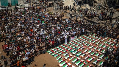 Palestinians gather at a mass funeral for 112 members of the Abu Sharia and Al Hassayneh families in Gaza city. EPA