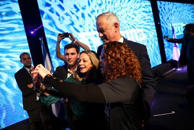 Blue and White party leader Benny Gantz, Mr Netanyahu's main challenger, poses with supporters during a campaign rally in Tel Aviv, Israel on Saturday, Feb. 29. Oded Balilty / AP