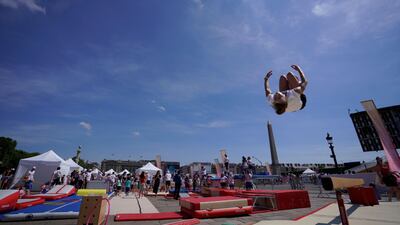 A woman jumps as she takes part in the "Journee Olympique" ("Olympic day") in Paris. A total of thirty Olympic and paralympic sports will be presented on Place de la Concorde in Paris. AFP