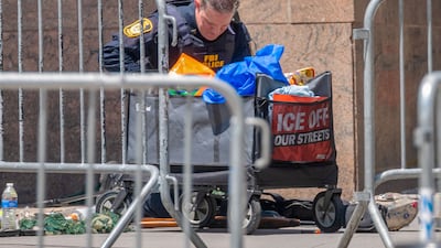 An investigator at the scene after an incendiary device went off outside a building housing Immigration and Customs Enforcement offices in New York. Getty Images