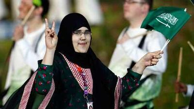 Saudi Arabia's Wojdan Ali Seraj Abdulrahim Shaherkani gestures as she walks with the contingent in the atheletes parade during the opening ceremony of the London 2012 Olympic Games.