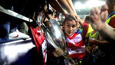 Antoine Griezmann of Atletico celebrates with the trophy. Getty