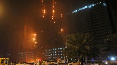 Fire and smoke billow from a high-rise building in Ajman. Five are believed to have suffered minor burns. Kamran Jebreili / AP