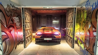 There aren't many centimetres to spare to drive through the graffiti-splashed doors. Antonie Robertson / The National