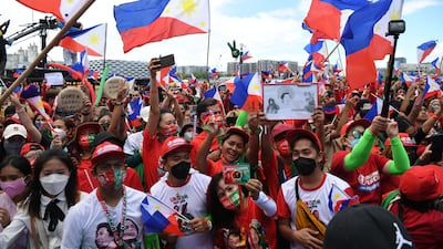 Supporters of Philippines presidential candidate Ferdinand Marcos Jr, son of the late dictator Ferdinand Marcos, flash the victory sign at a rally in Paranaque City, suburban Manila. AFP