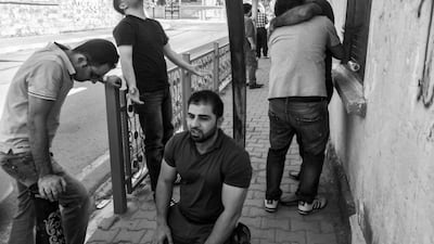 KIRKUK, IRAQ: Kamaran Najm's friends and family react after he called on the phone from ISIS captivity.