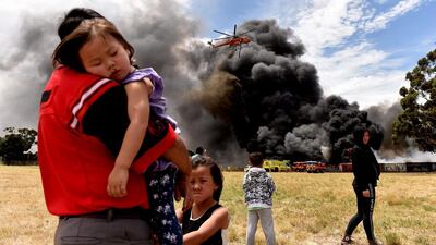 A helicopter drops water to battle a large tyre fire in Broadmedows, Melbourne, Australia. Tracey Nearmy / EPA