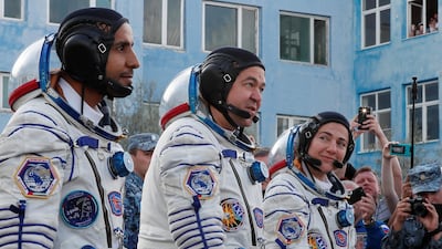 Jessica Meir, Oleg Skripochka and Hazza Ali Al Mansouri approach the launchpad at the Baikonur Cosmodrome. Shamil Zhumatov / Reuters