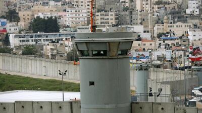 An Israeli soldier on duty at a security tower at the separation wall, near the checkpoint of Kalandia in the West Bank. Atef Safadi / EPA
