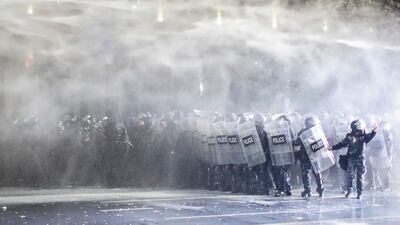 Police use water cannon and tear gas to disperse Georgian opposition supporters protesting outside the parliament in the capital Tbilisi. EPA