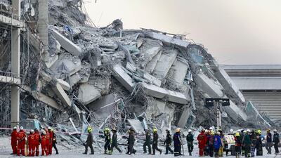 Rescuers at a high-rise building under construction that collapsed after a 7. 7 magnitude earthquake hit Bangkok, Thailand. AP Photo