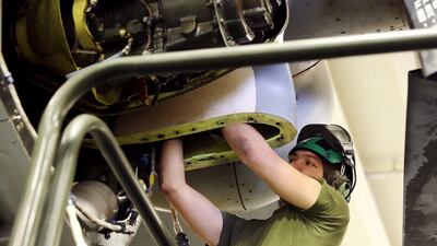 A US Marine maintains an MV-22 Osprey aircraft.
