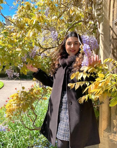 Ana Diamond stands under wisteria flowers at Balliol College, at the University of Oxford. Photo: Ana Diamond