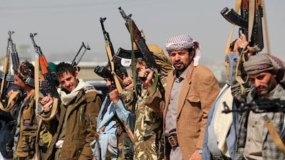 Yemeni militants stand with their arms, as they gather to mobilize fighters in the Houthi-controlled capital, Sanaa on November 2, 2025. Huthi rebel forces launched an armed rebellion in 2014 after years of protesting discrimination and marginalization, seizing control of the capital Sanaa and other several provinces. (Photo by Mohammed HUWAIS / AFP)