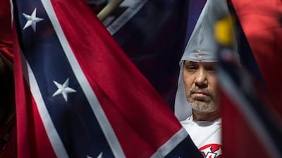 A group of men dressed in the outfits of the white supremacist group posed outside the town's Islamic centre. AFP.