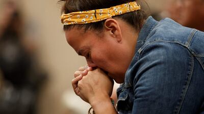 Carlea Stonestand, a relative of stabbing victim Bonnie Burns, fights back tears during the news conference in Saskatoon. AFP