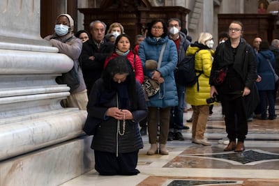 People observe a moment of silence as the body of the late Pope Emeritus Benedict XVI lies in state. EPA