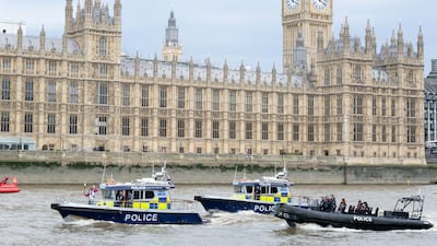 Batonbearer-Anthony Okereafor carries the baton on a Marine Police boat on the River Thames, in London. Getty Images