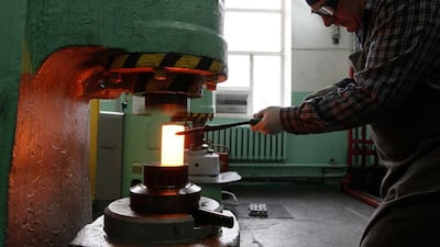 A worker forms on an ingot of 99.98 per cent pure platinum at the Krastsvetmet non-ferrous metals plant in Siberia. Krastsvetmet plans to launch a new refinery complex at its Siberian base. Ilya Naymushin / Reuters