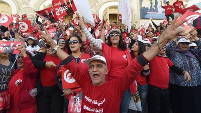 Supporters of Tunisian presidential candidate Beji Caid Essebsi shout slogans and wave flags on Bourguiba avenue in the capital, Tunis. Photo: Fadel Senna / AFP