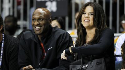 Lamar Odom and his former wife Khloe Kardashian at a basketball game in 2011. Odom was hospitalized on October 13, 2015, after he was found unresponsive at a Nevada brothel, law enforcement officials said. Danny Moloshok / Reuters