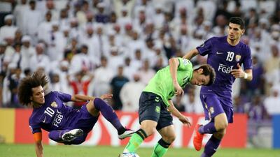 Al Ain midfielder Omar Abdulrahman, left, flies into tackle during the Asian Champions League final second leg. Pawan Singh / The National