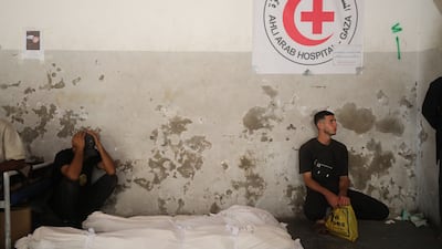 Mourners gather at Al Ahli Hospital in Gaza city by the bodies of Palestinians killed by Israeli fire after crossing the ceasefire line. AP