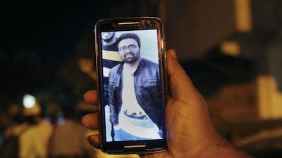 A relative shows a picture of Syed Areeb Ahmed, a Pakistani citizen who was killed. AP Photo