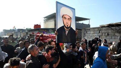 Mourners carry the coffin of prominent activist Wissam Al Ghrawi in Basra AP