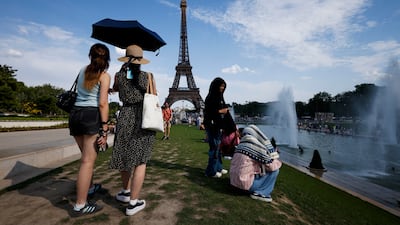 A woman takes shelter from the intense summer heat in Paris over the weekend. Photo: EPA