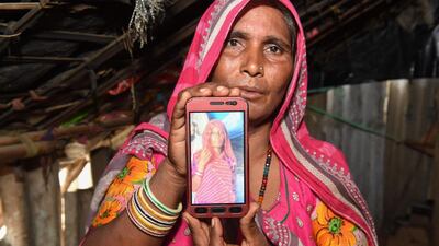Mohinidevi Nath displays a photo on a mobile phone of her cousin Shantadevi Nath, who was killed by a mob that falsely believed she was intent on abducting children, on the outskirts of Ahmedabad in India's western Gujarat state on June 27, 2018. Indian police urged people on June 27 not to believe false rumours spread on WhatsApp after a woman was killed and a dozen hurt in the latest mob attacks to leave authorities looking powerless. Sam Panthaky / AFP