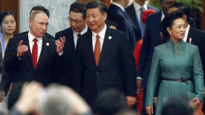 Chinese resident Xi Jinping, centre, his wife Peng Liyuan and Russian president Vladimir Putin, left, arrive for a welcome banquet for the Belt and Road Forum at the Great Hall of the People in Beijing on May 14, 2017. Wu Hong / Pool Photo via AP