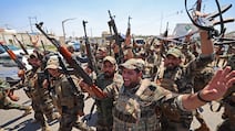 Members of the Saraya Al Salam militia celebrate their separation from the Sadrist movement and integration into the Iraqi security forces, in Samarra, Iraq. AFP