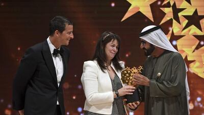 Sheikh Mohammed bin Rashid, Vice President and Ruler of Dubai, presented Maggie MacDonnell with the award on the final day of the Global Education and Skills Forum. Martin Dokoupil / AP Photo