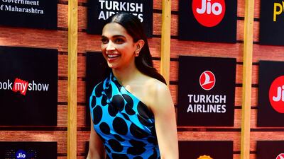 Never one to shy away from a fashion moment, Deepika Padukone wore a bold blue polka dot dress by Marmar Halim for the 21st Jio MAMI Mumbai Film Festival on Sunday night. Photos: AFP