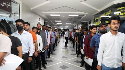 Candidates queue to apply for the jobs as taxi drivers, during the RTA's recruitment day at the Privilege Labour Recruitment Office, in Dubai. Pawan Singh / The National