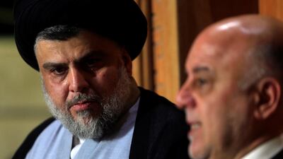 Iraqi Shiite cleric Moqtada Al Sadr, whose bloc came first, looks at Iraqi Prime Minister Haider Al Abadi, whose political bloc came third in a May parliamentary election, during a news conference in Najaf, Iraq June 23, 2018. Alaa al-Marjani / Reuters