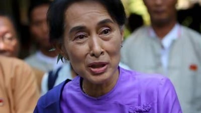 Myanmar democracy icon Aung San Suu Kyi is surrounded by NLD party officials as she meets with the media after being re-elected leader of the National League for Democracy (NLD) party during their first ever nationwide congress within 25 years, in Yangon, Myanmar.